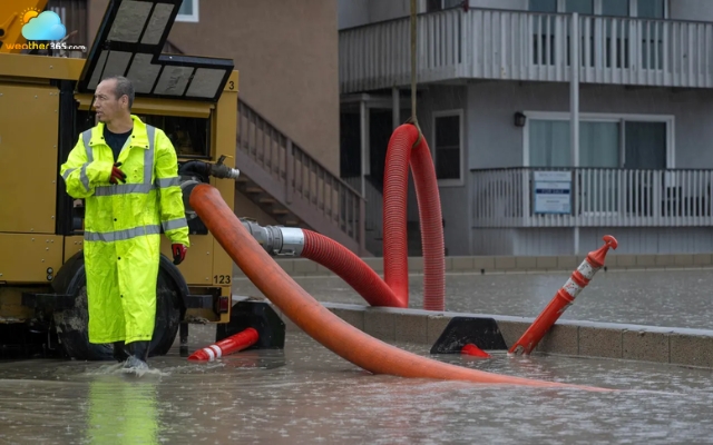 Seal Beach workers pump floodwater away from homes during Hurricane Marie on September 6.