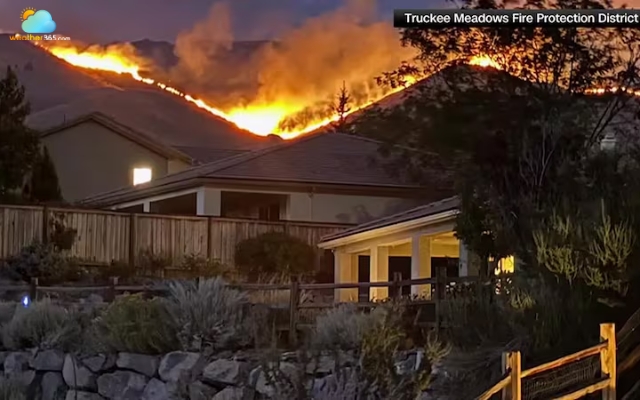 Smoke rises from the fast-moving Hawk Fire near Reno as strong winds fuel the blaze.